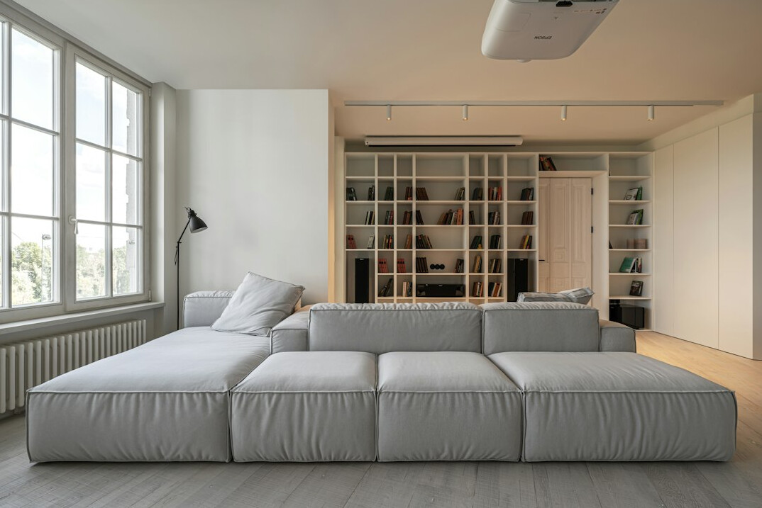 Modern office lounge area with couches and large windows